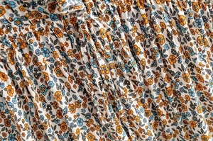 Macro detail of floral ruffle dress fabric with delicate yellow and blue patterns
