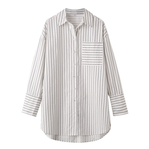 Close-up of horizontal striped pocket and button detail on a long sleeve shirt