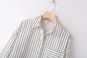 Close-up of black and white striped shirt collar with pocket and size XS label