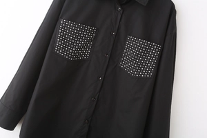 Detail of black poplin shirt with silver rivet studs on front flap pockets