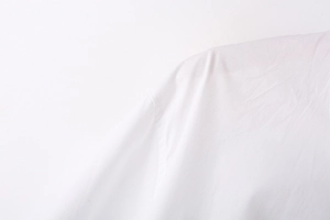 Detailed close-up of precise stitching and fine cotton texture on white Y2K long sleeve shirt