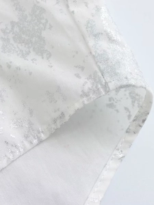 Y2K loose white shirt with metallic asymmetric hem and silver foil splash print detail