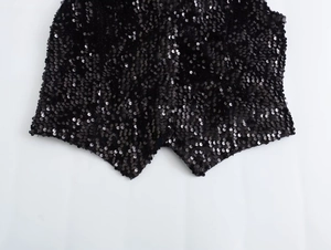Detailed view of the black sequined hem with asymmetrical sharp pointed tailoring