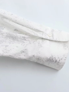 Minimalist Y2K white shirt featuring silver metallic print details and buttoned cuffs