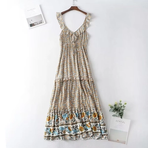 Floral V-neck bohemian maxi dress with ruffle straps and tiered skirt on wooden hanger