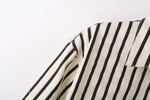 Detail of the high-quality stitching on a black and white striped poplin shirt collar