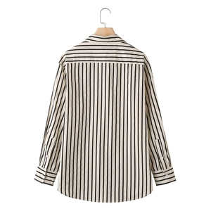 Back view of women's long sleeve black and white vertical striped poplin shirt on hanger