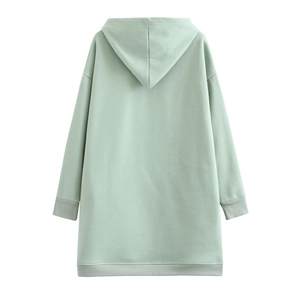 Detailed view of light green oversized hoodie with ribbed cuffs and hem on white background