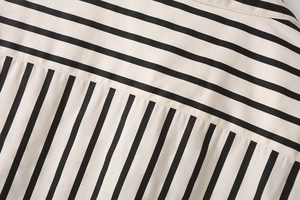Close-up of fine double-stitching and high-density striped poplin fabric texture