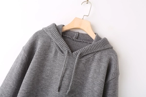 Detail shot of a dark grey Y2K hooded knit sweater featuring rib knit trim and drawstrings