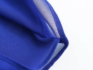 Macro shot of royal blue sheer chiffon blouse showing fine stitching and fabric texture