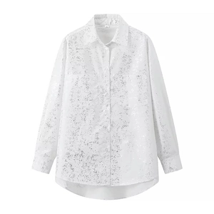 Detail view of white long sleeve shirt featuring silver metallic foil print and chest pockets