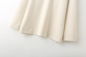 Close-up of ribbed cuffs and hem on heavy cream sweatshirt with double-needle stitching