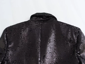 Macro shot of high-density black sequins on the collar of a Y2K French style cropped jacket