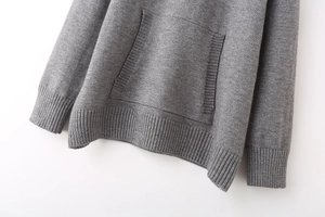 Detail view of the kangaroo pocket and ribbed knit cuffs on this grey Y2K hoodie