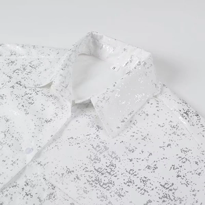 Detail of white Y2K shirt collar featuring metallic silver print and size S neck label