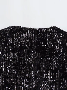 Elegant black sequin vest for women featuring shimmering fabric and intricate detail