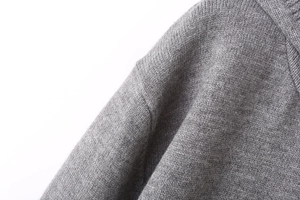 Detailed macro view of the fine-knit shoulder seam and grey fabric texture on this Y2K sweater