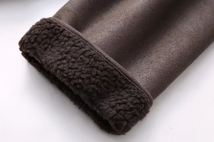 Detail of dark brown faux suede jacket with thick faux shearling lining and neat stitching