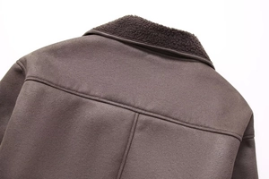 Detail of faux shearling collar and brown suede fabric on the back of the jacket