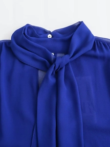 Elegant royal blue pussy-bow chiffon blouse with delicate neck button and sheer texture