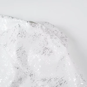 Detail of white Y2K shirt featuring unique metallic silver foil print and texture