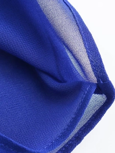 Close-up of vibrant royal blue Y2K chiffon blouse fabric showing fine mesh texture