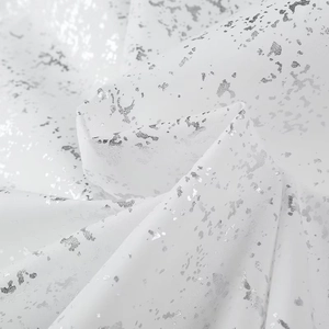Detailed view of silver foil print texture on white y2k long sleeve shirt fabric