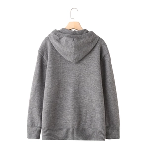 Back view of a grey oversized hooded knit sweater with drop shoulder and ribbed cuffs