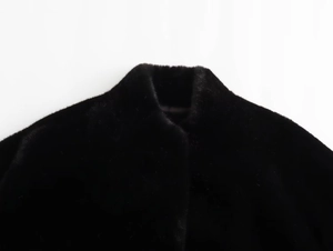 Close-up of the stand-up collar and smooth faux fur texture on this black pilot jacket