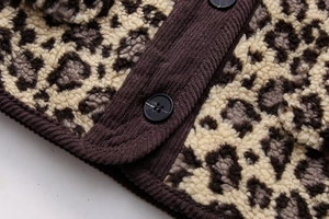 Close-up of leopard print fleece jacket with corduroy trim and black round buttons