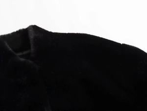 Detailed close-up of premium black faux fur texture on a Y2K style aviator jacket