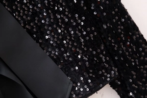 Detailed macro view of sparkling black sequins and premium grosgrain ribbon texture