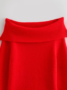 Detail of red off-the-shoulder knit sweater showing premium ribbed texture and collar
