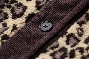 Macro detail of Y2K leopard print fleece jacket with ribbed trim and black matte button