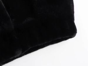 Close-up of black faux fur jacket showing dense glossy texture and soft high-quality fibers