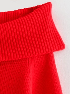 Detailed macro shot of red ribbed knit sweater collar showing soft fabric texture