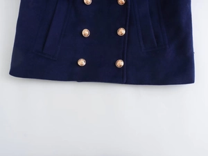 Detail of navy wool coat featuring vintage gold embossed buttons and woven texture