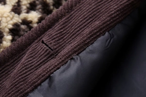 Close-up of leopard faux shearling fabric with ribbed knit edges and smooth lining