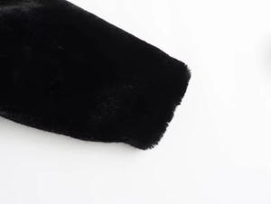 Close-up detail of high-quality black faux fur texture on a Y2K bomber jacket sleeve
