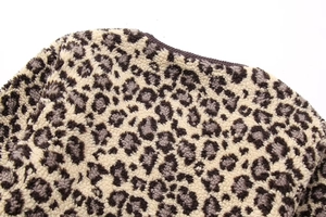 Detailed macro view of soft faux fur leopard print fabric with high-density stitching