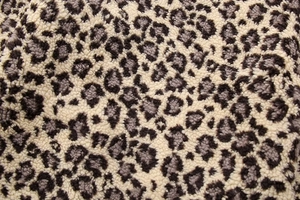 Close-up detail of soft leopard print fleece fabric texture with black and grey pattern