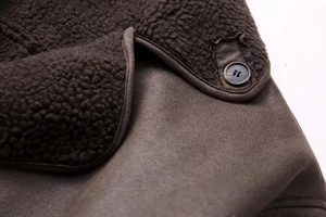 Close-up of suede fabric and soft faux shearling lining with resin button detail