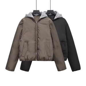 Detail of Y2K puffer jackets in dark brown and black with detachable grey hoodies
