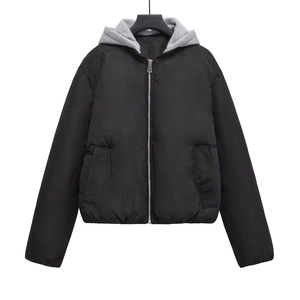Close-up of Y2K puffer jacket with detachable gray hood and black quilted nylon fabric