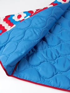 Quilted V-neck jacket with blue wave stitching and red trim detailing