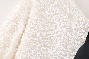 Macro detail of high-density white sequin embroidery on Y2K slim-fit top fabric
