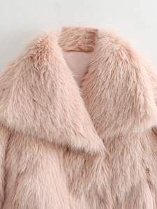 Detail of pink faux fur coat showing wide lapel collar and plush long hair texture