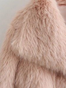 Detailed macro view of high-quality light pink faux fur texture on a winter coat