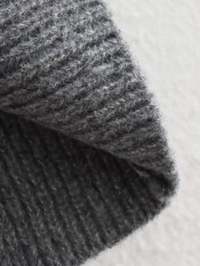 Detailed close-up of grey rib-knit fabric texture with soft wool-like fiber details